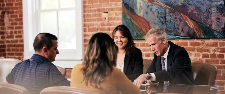 LoAn Kim Vo and Sean Michael Lyons talking to clients