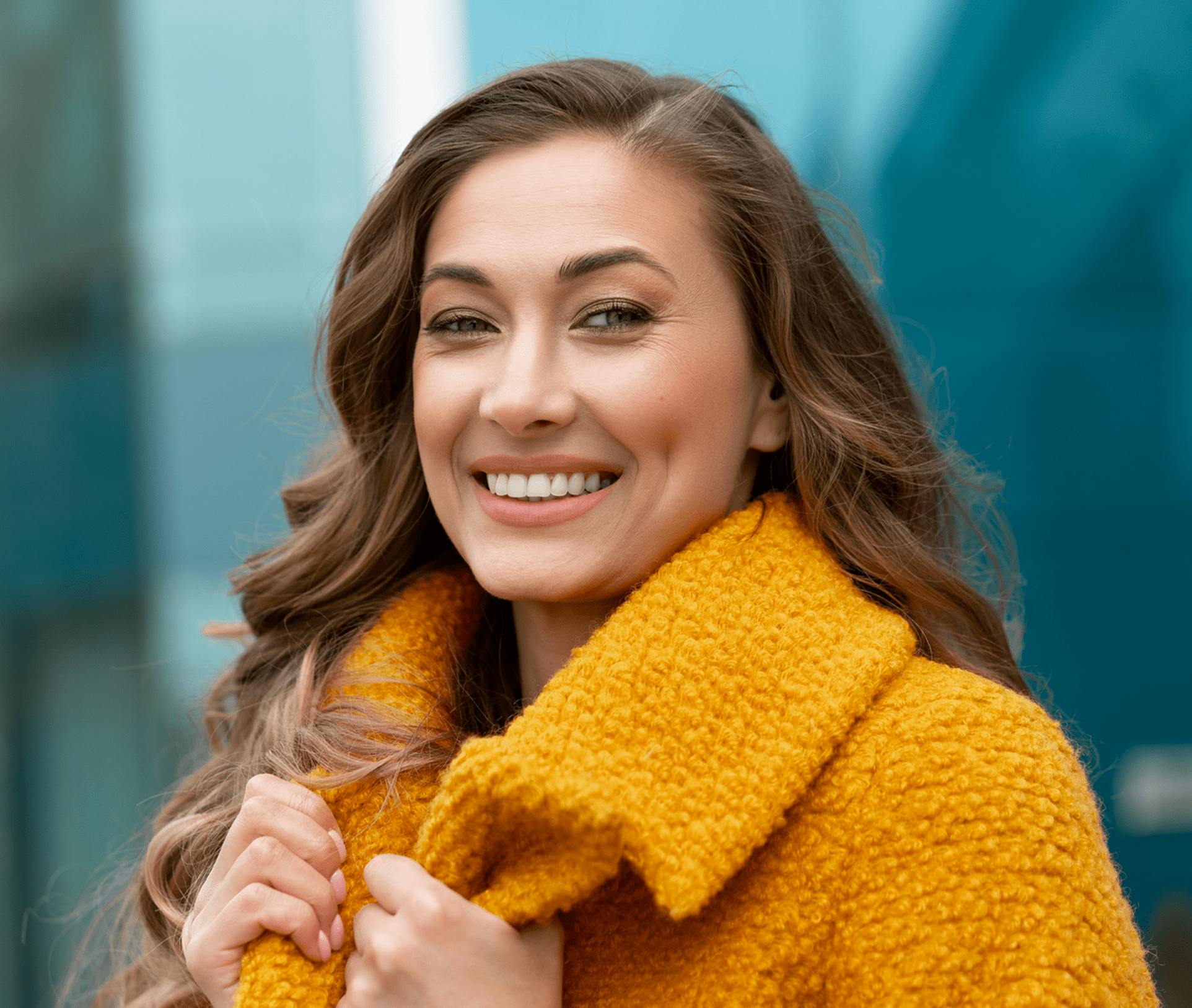 smiling woman holding her jacket collar