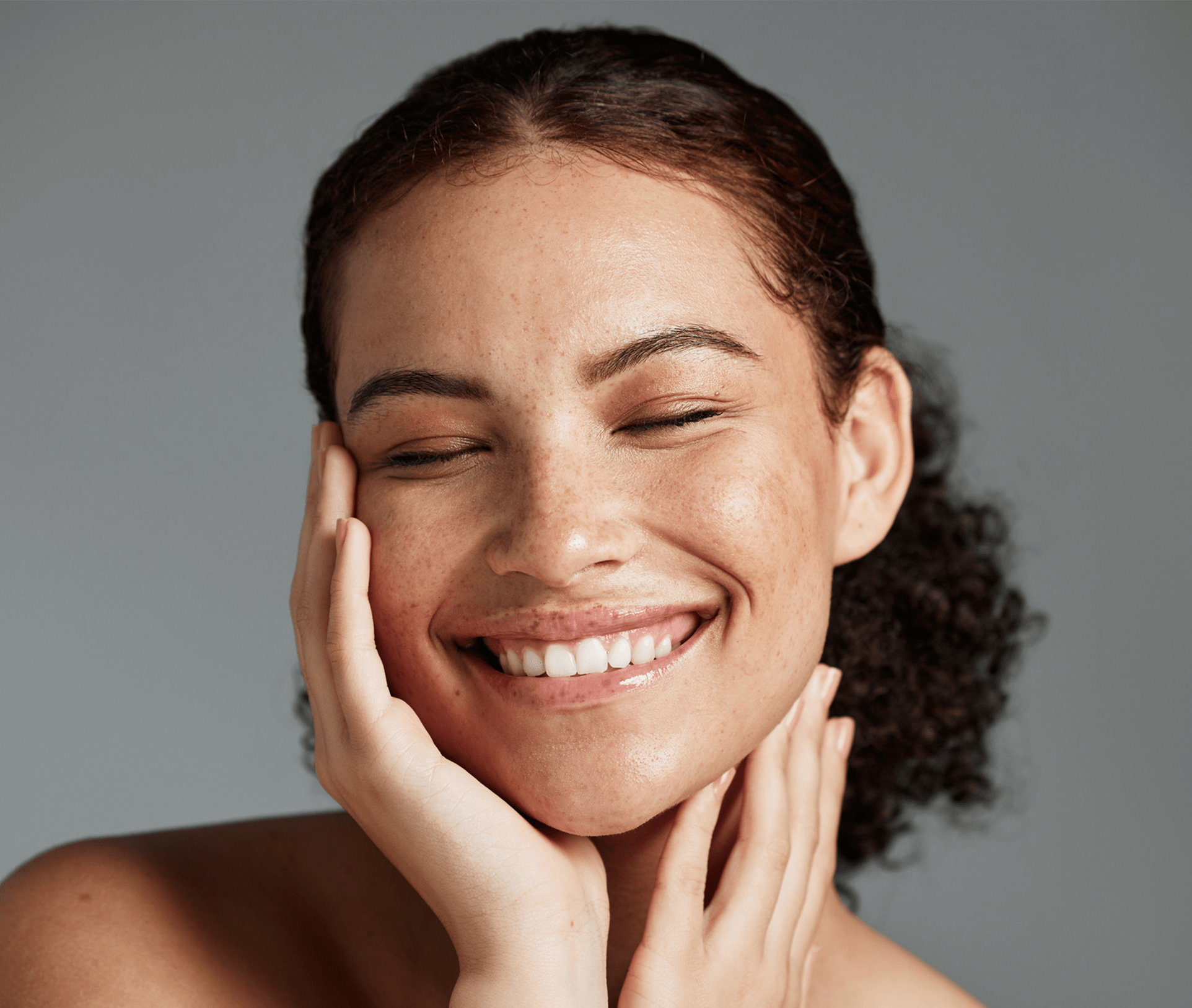 smiling woman cupping her face