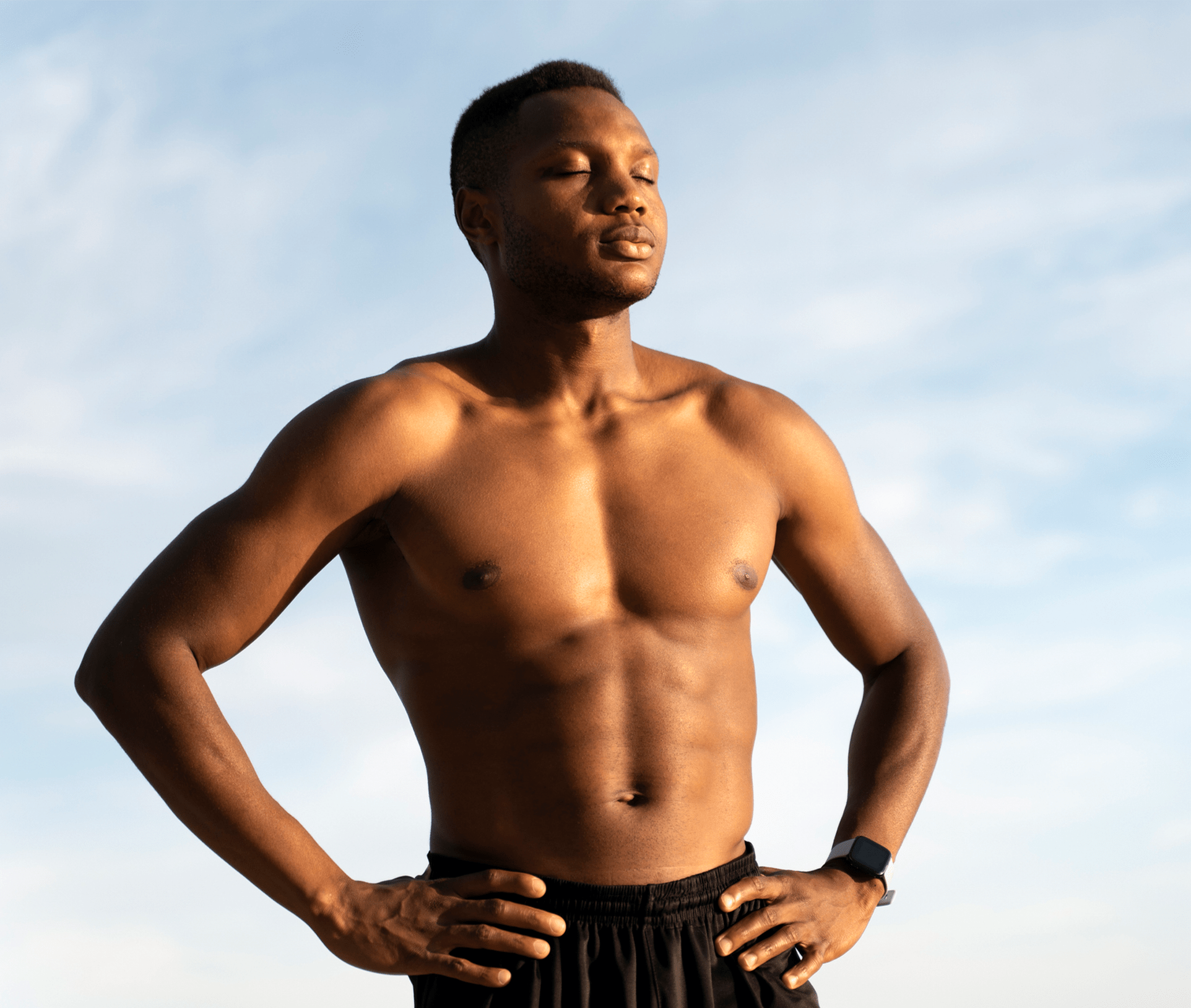 shirtless man with his hands on his hips