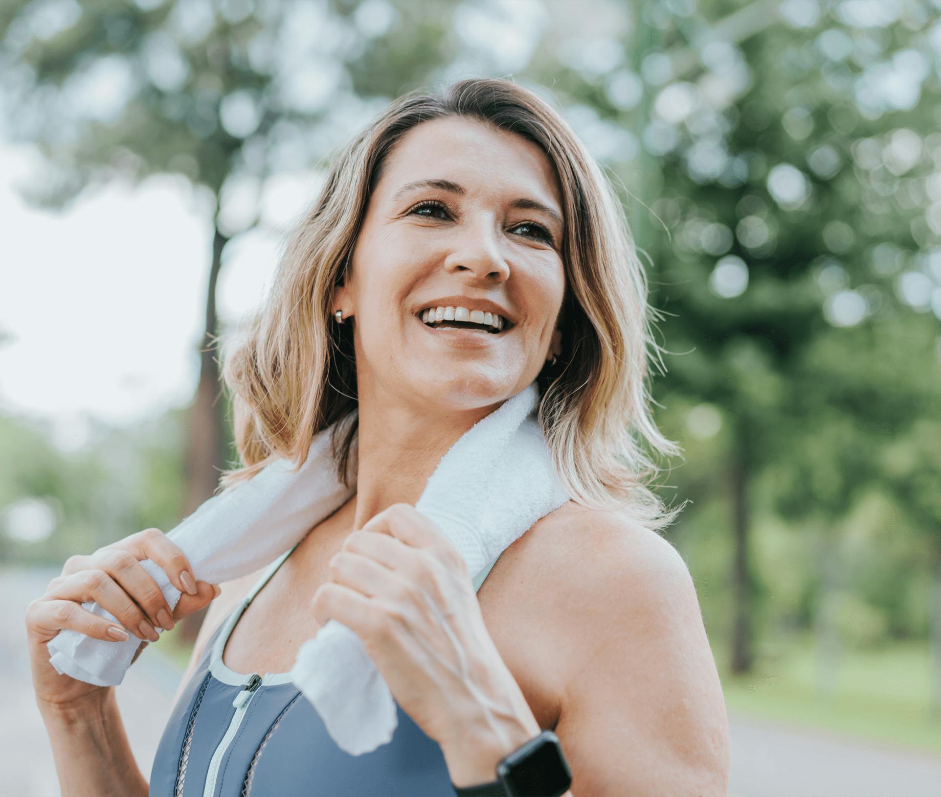 smiling woman with a towel around her neck