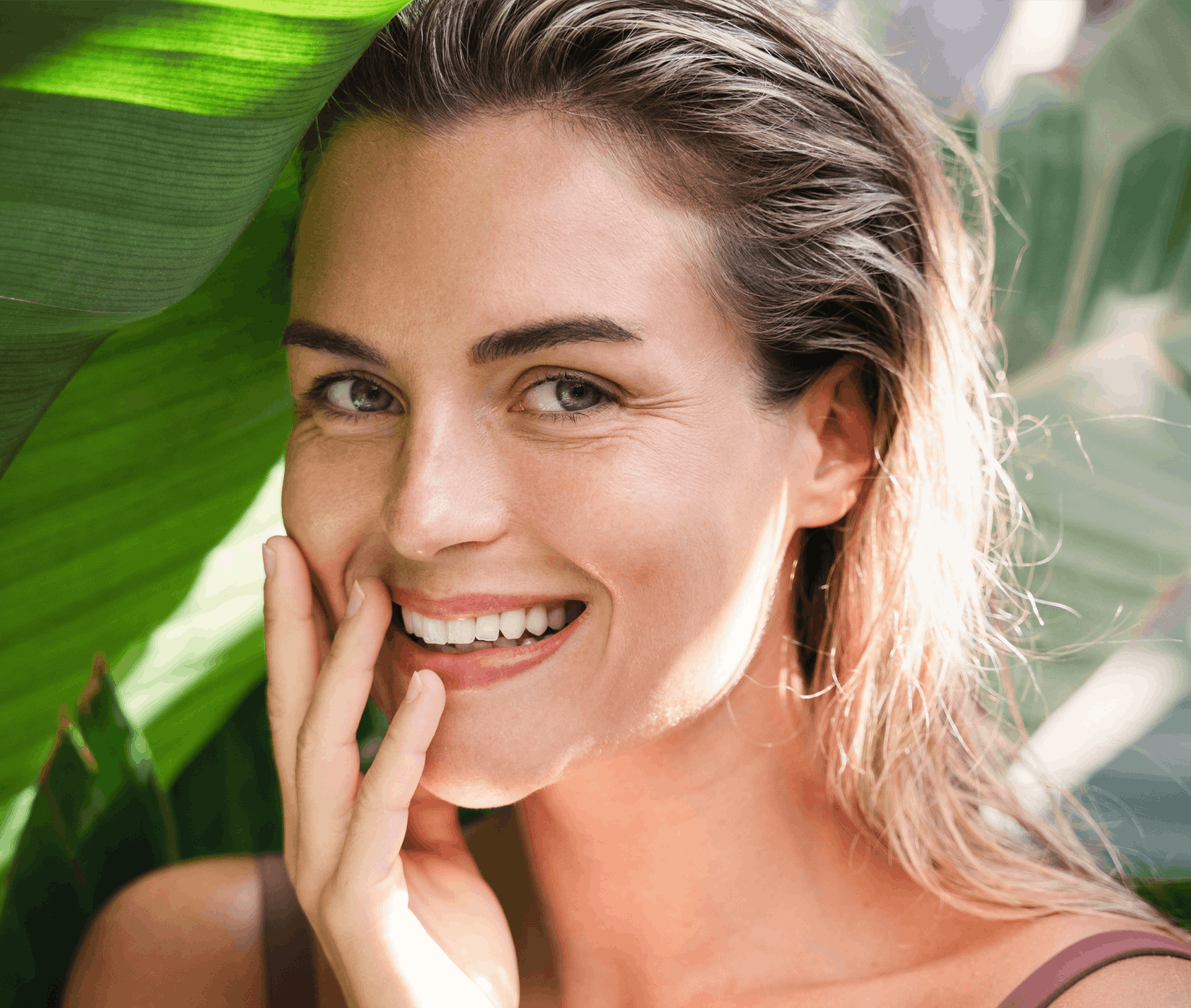smiling woman touching her face