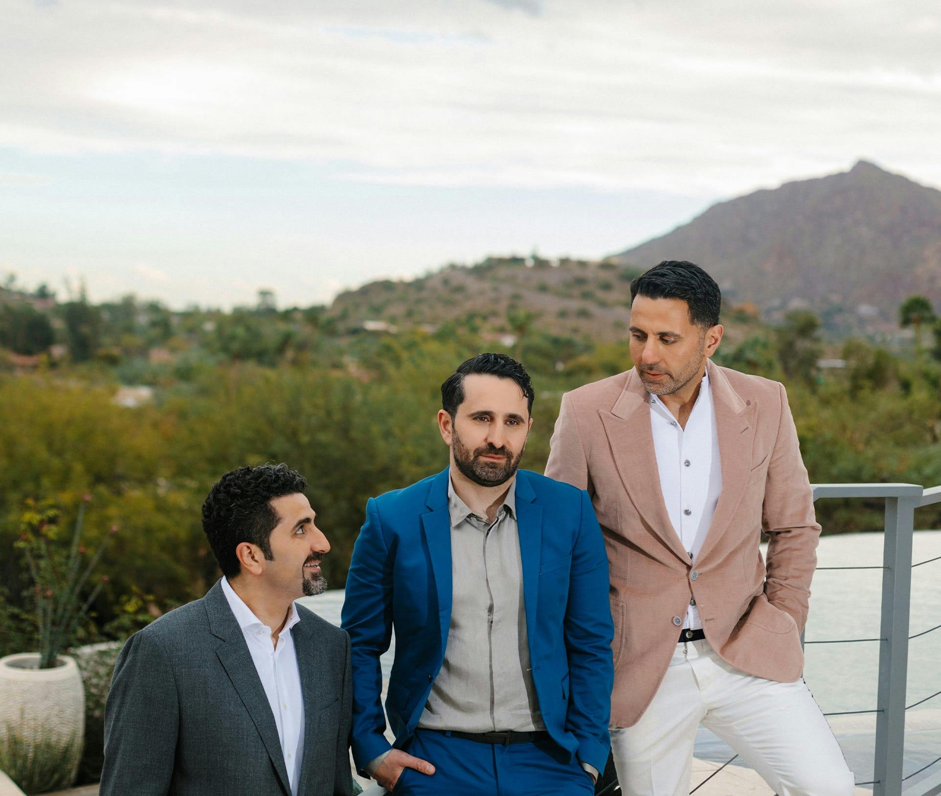 three doctors standing against stair rails