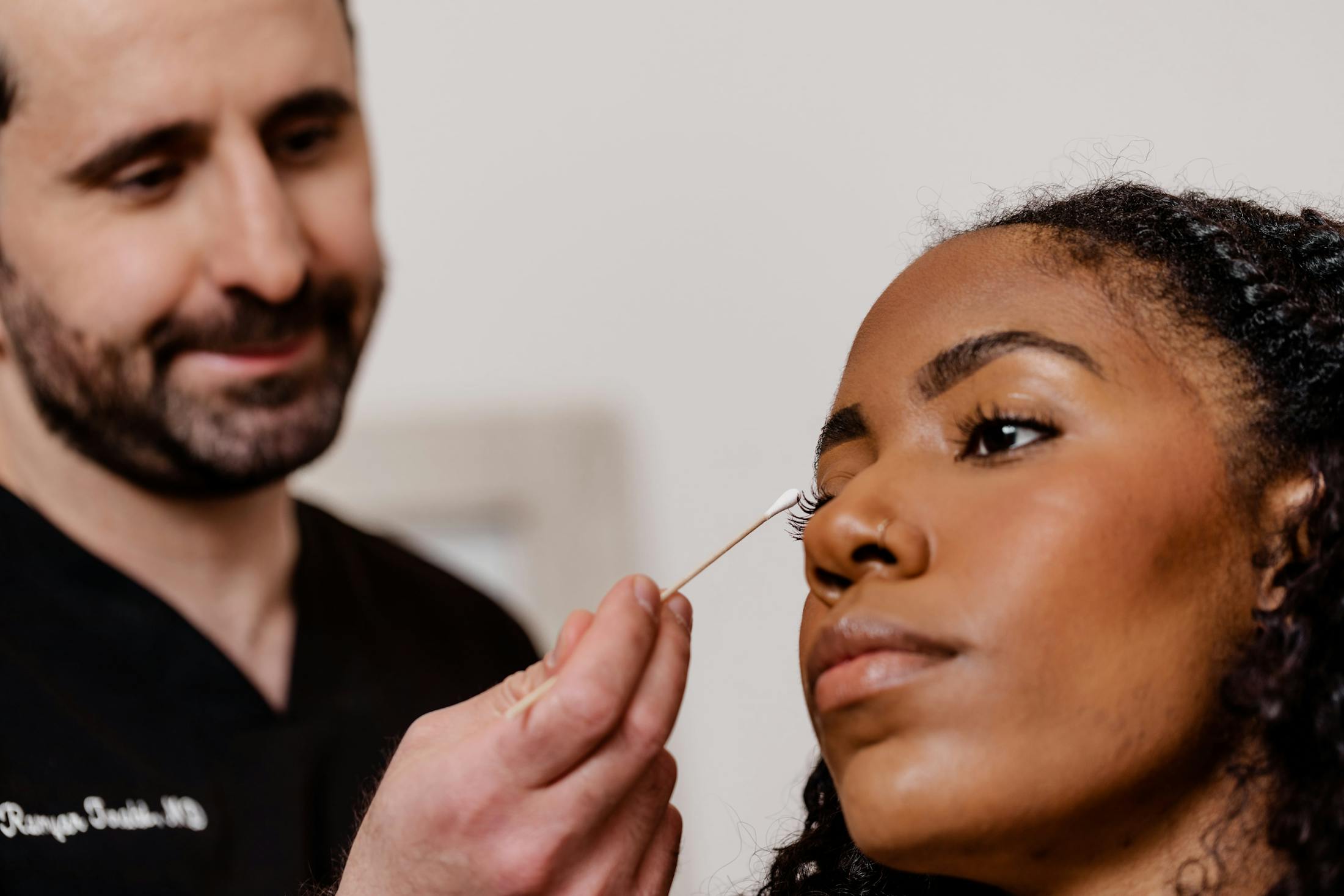 doctor pointing to a patient's face with a q-tip