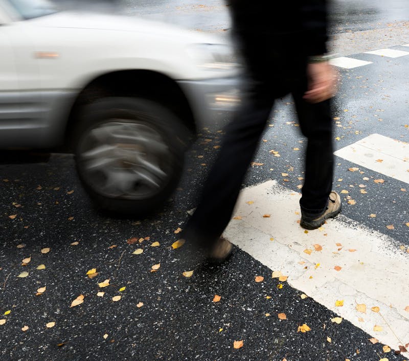 pedestrian crossing the street as a car approaches