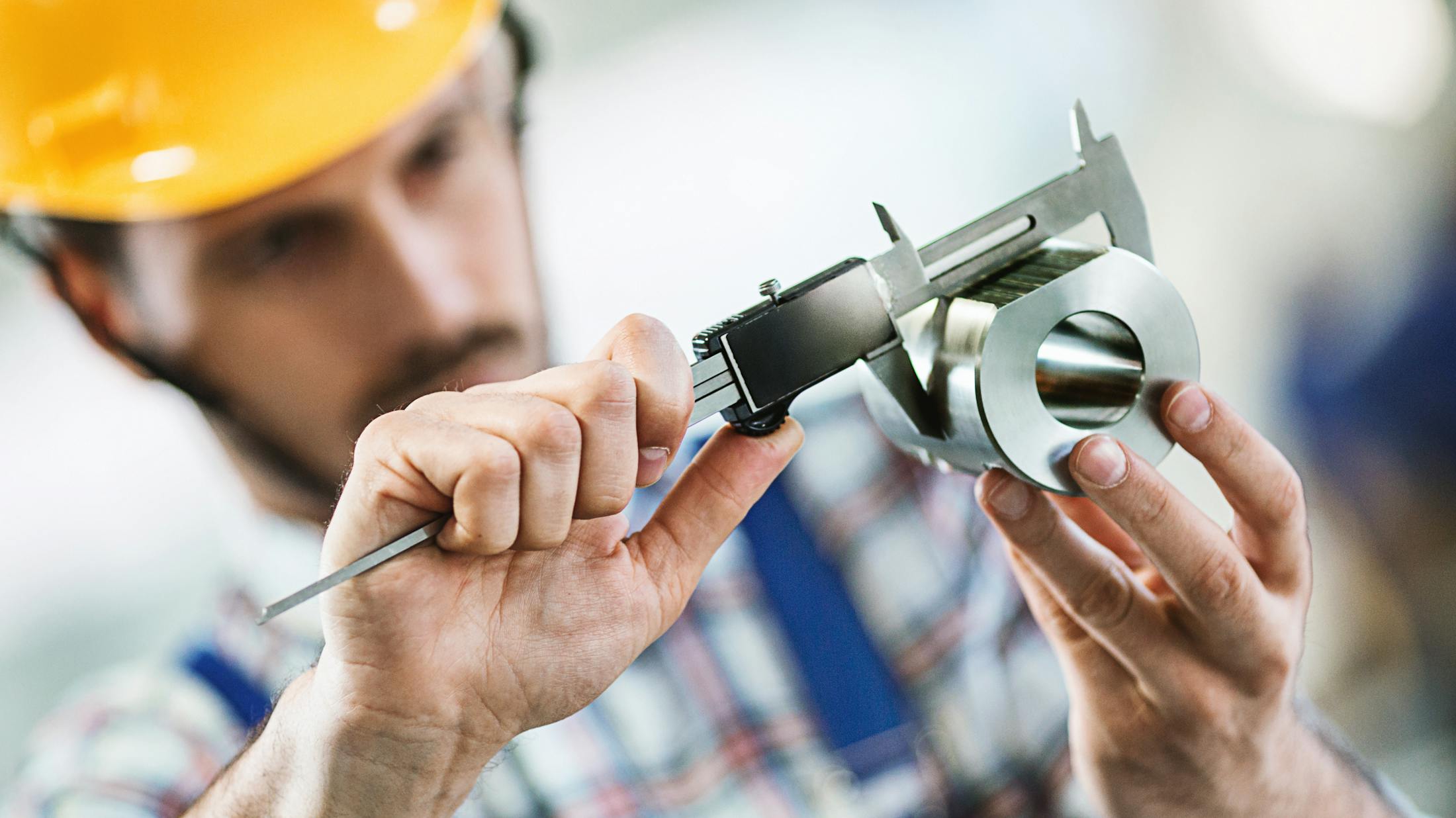 Man inspecting a metal part