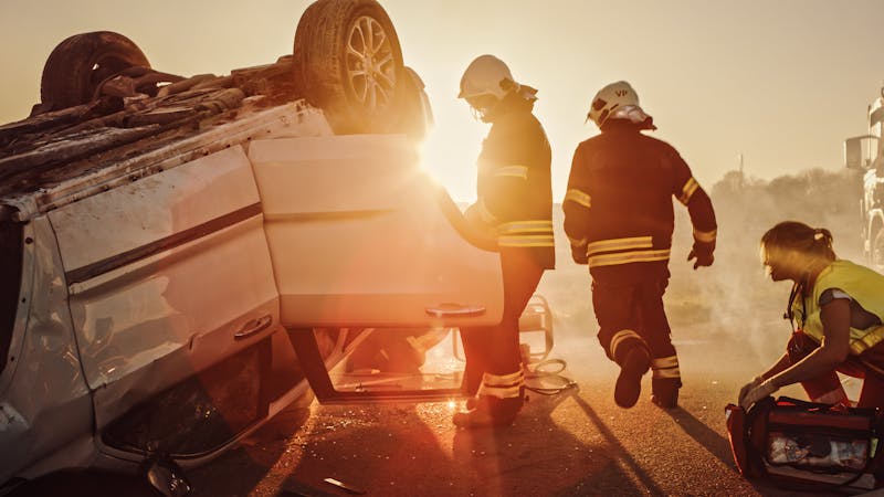 Paramedics and Firefighters Plan Rescuing Passengers Trapped in Rollover Vehicle