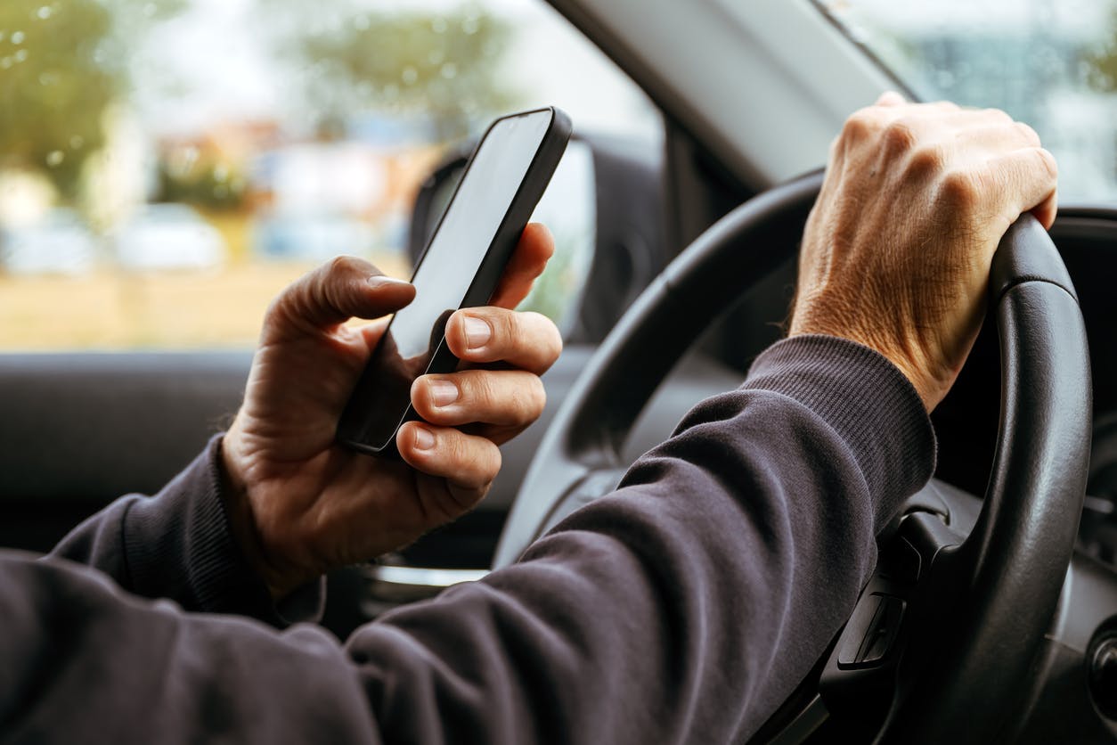 A man texting while driving