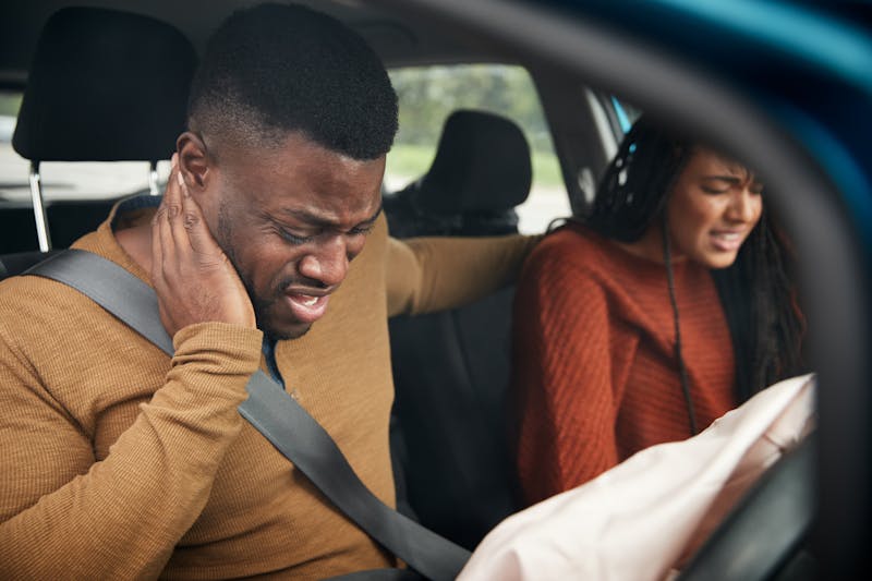 Image of two people in a car that just got in an accident