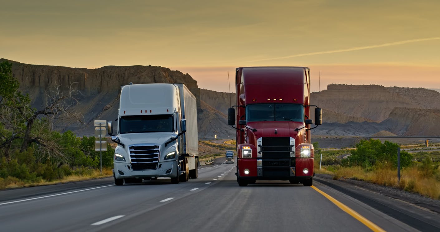 two trucks driving nect to each other