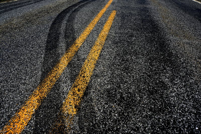 A road with swerve marks from a car