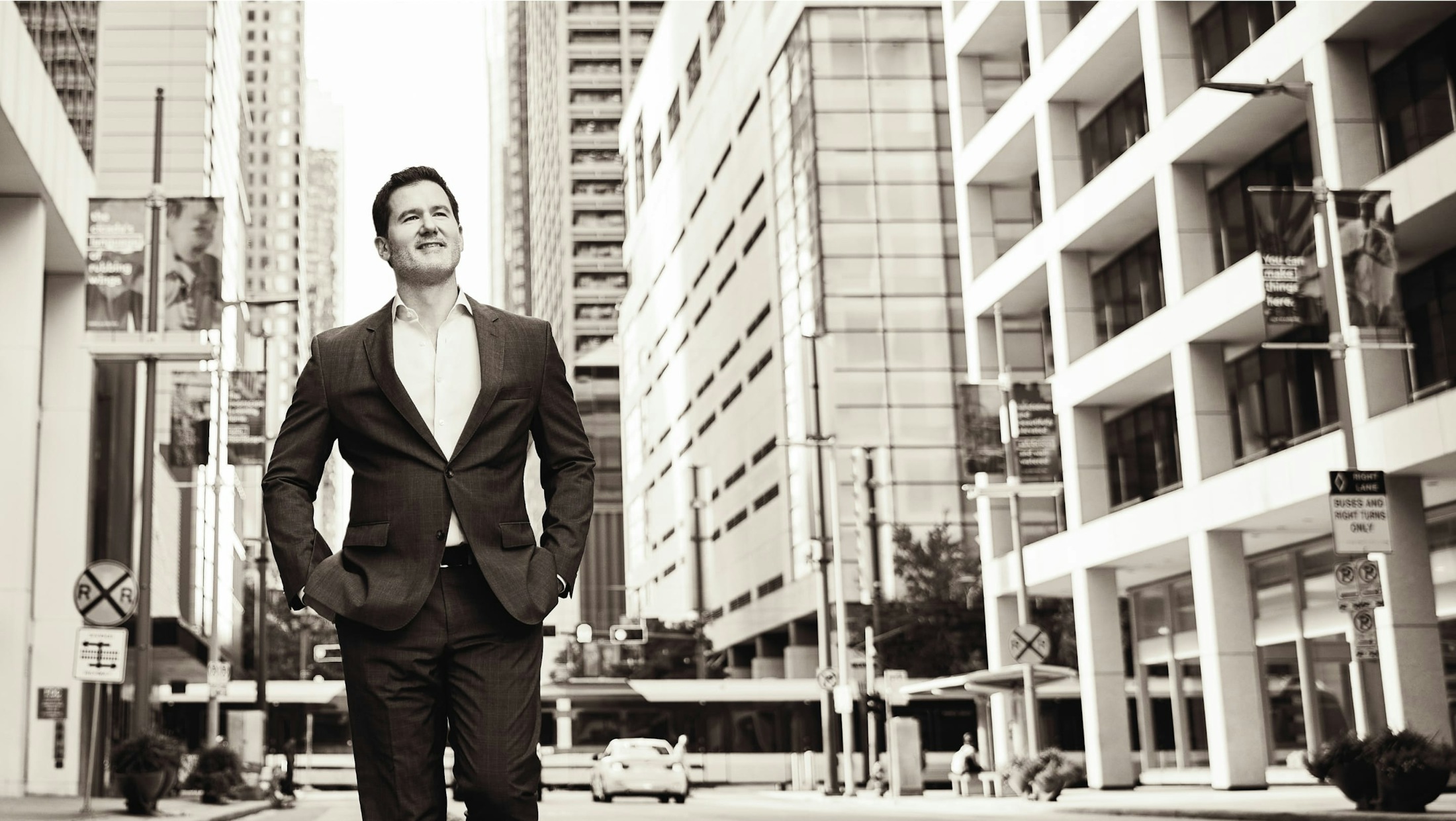 Joshua P. Davis walking on a sidewalk in downtown Houston