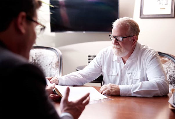 Man being handed papers to sign