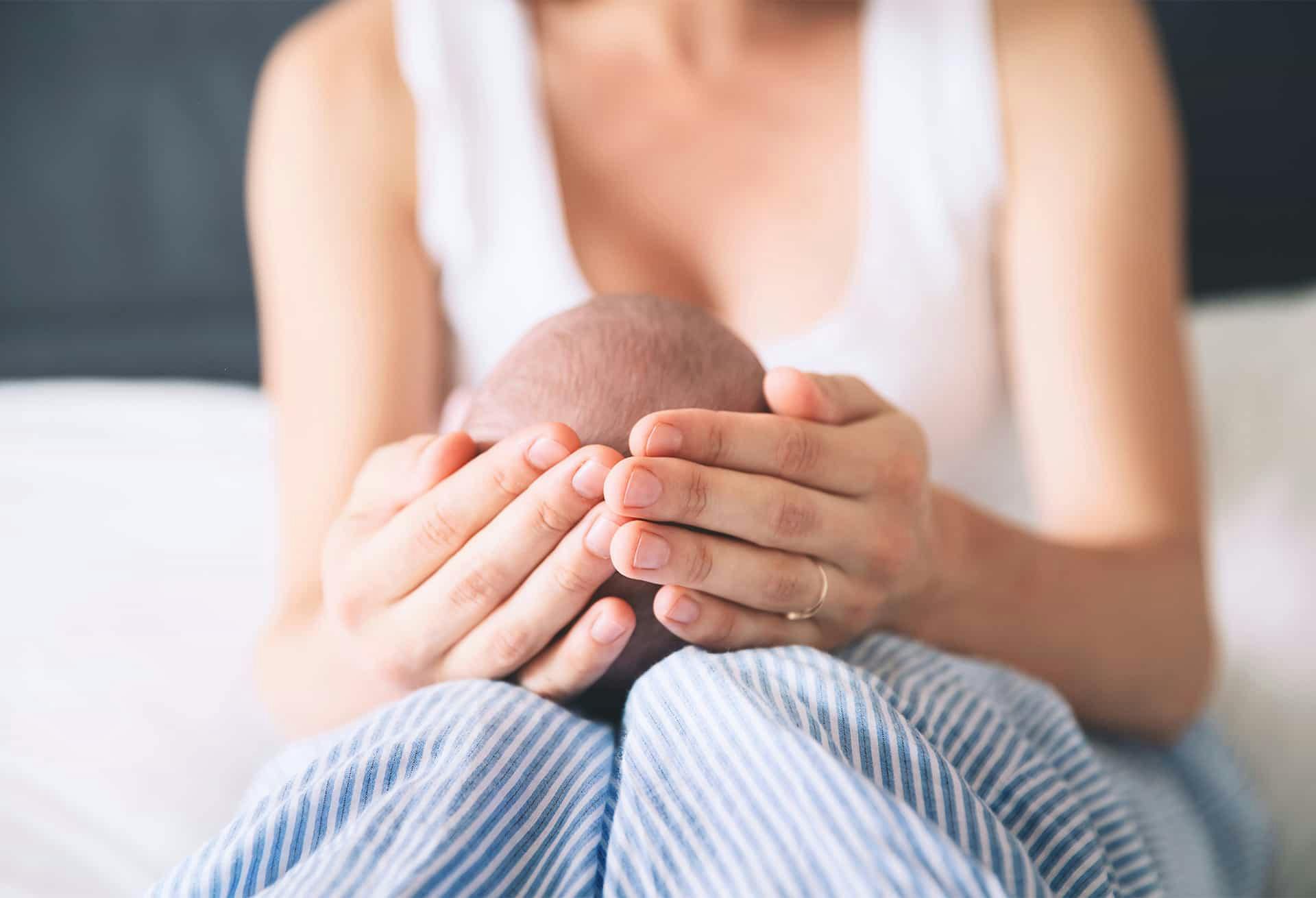 A woman holding her baby