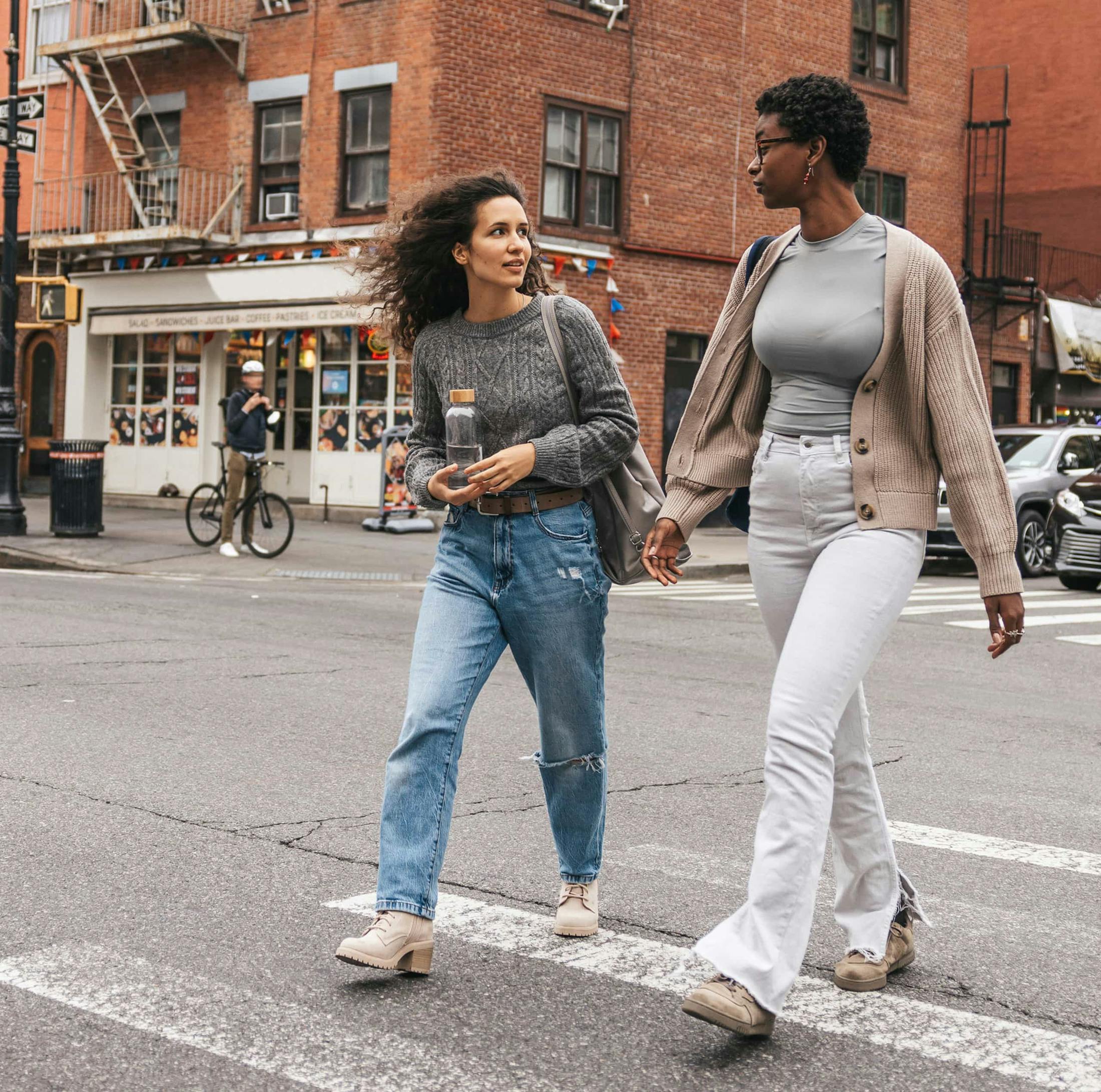 Two women walking across the street