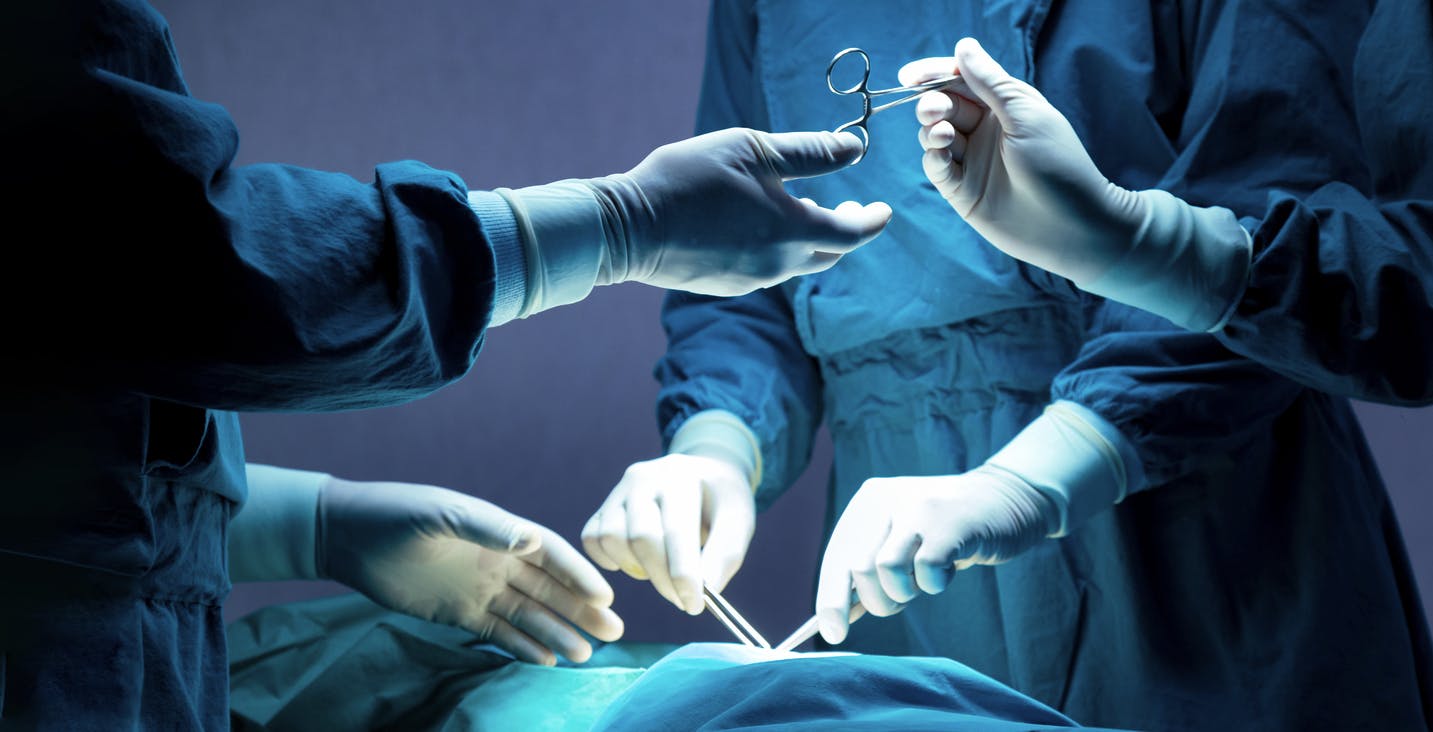 Doctors performing surgery on person