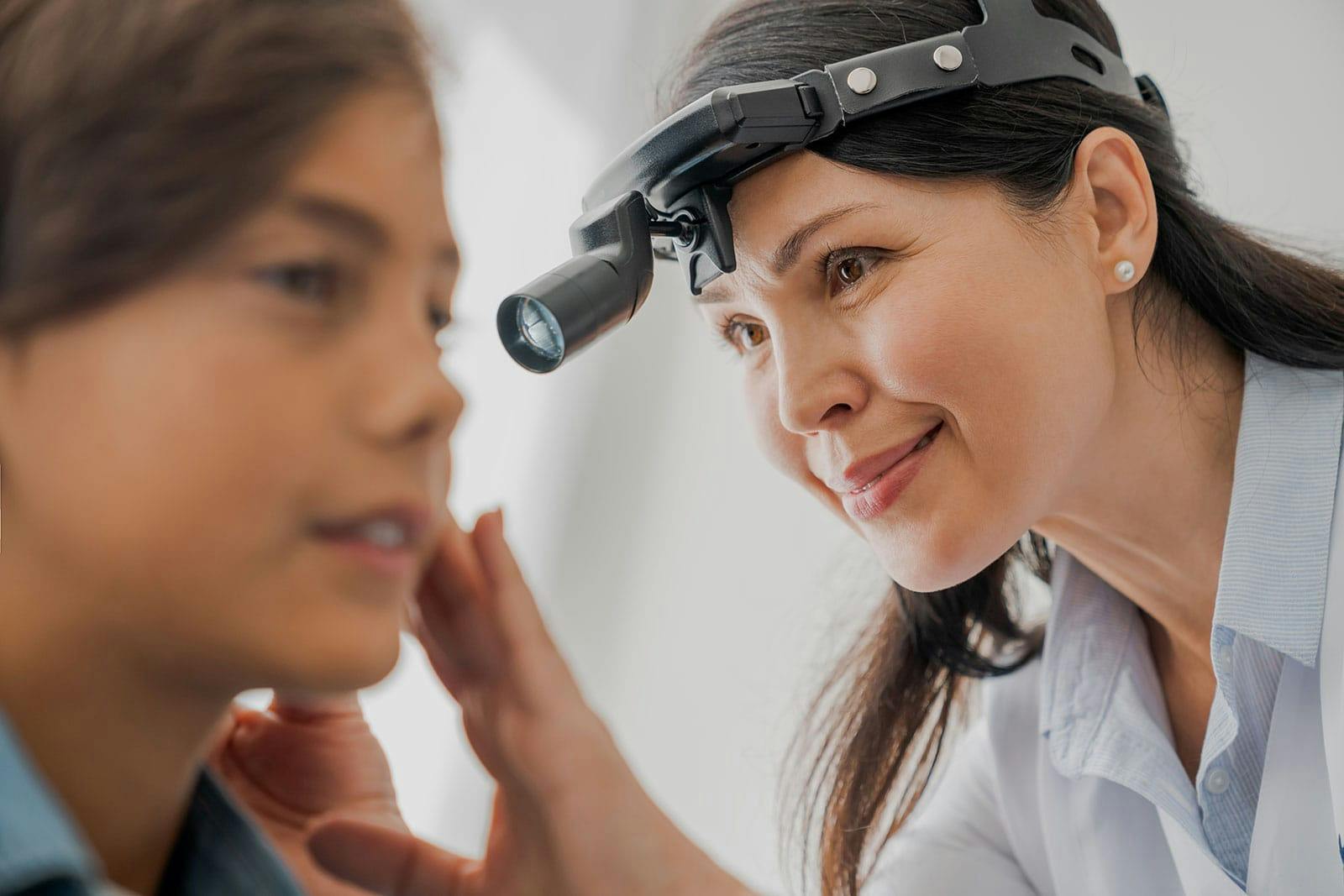Provider examining at a child's ears