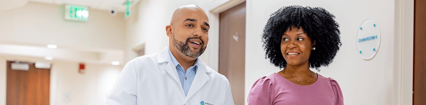 doctor and patient walking together