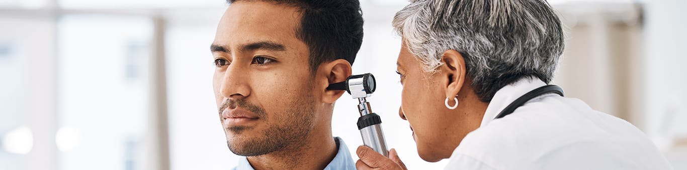 doctor looking in patients ear