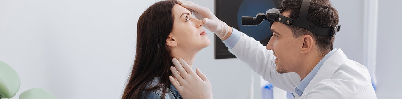 doctor examining patients nose area