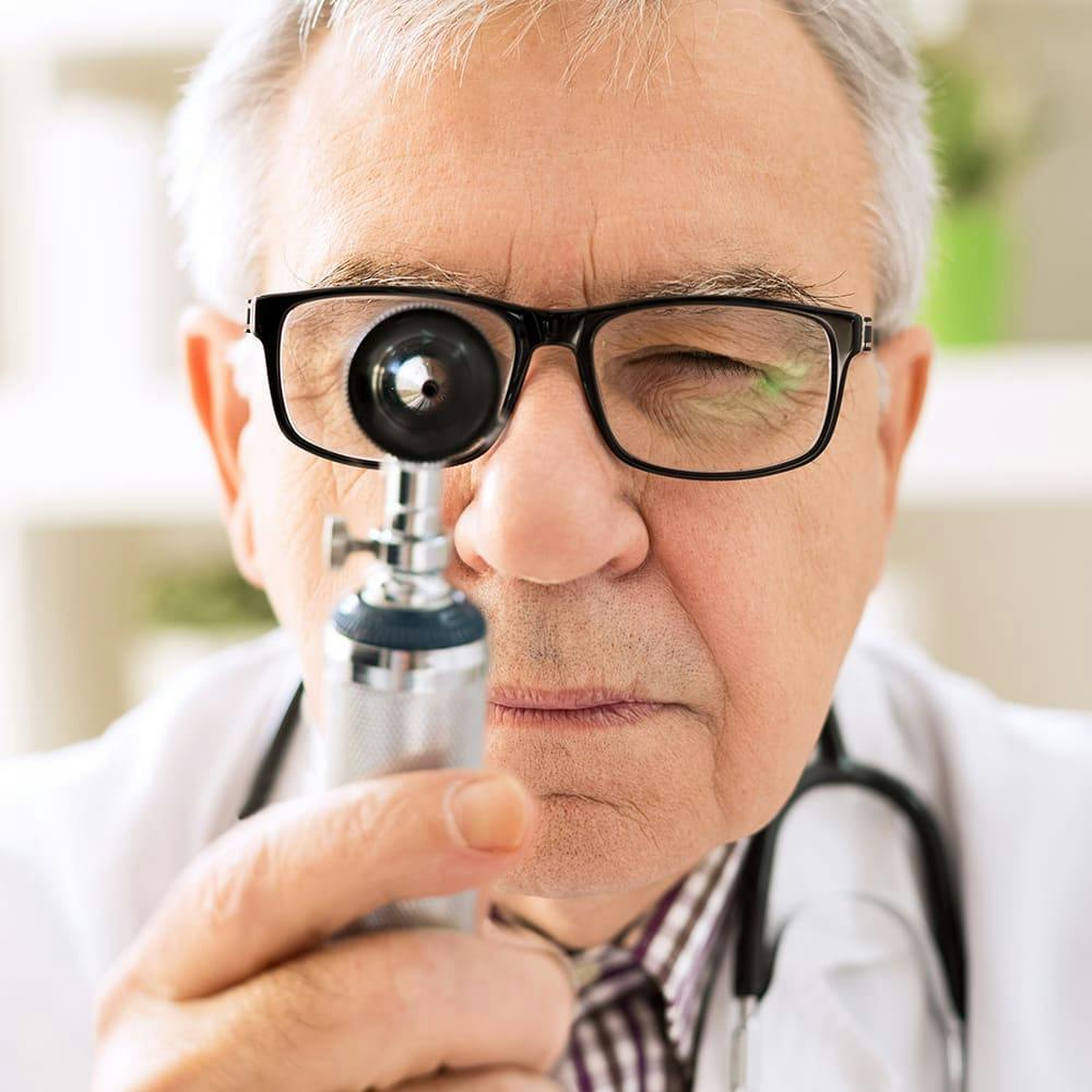 doctor looking into a microscope