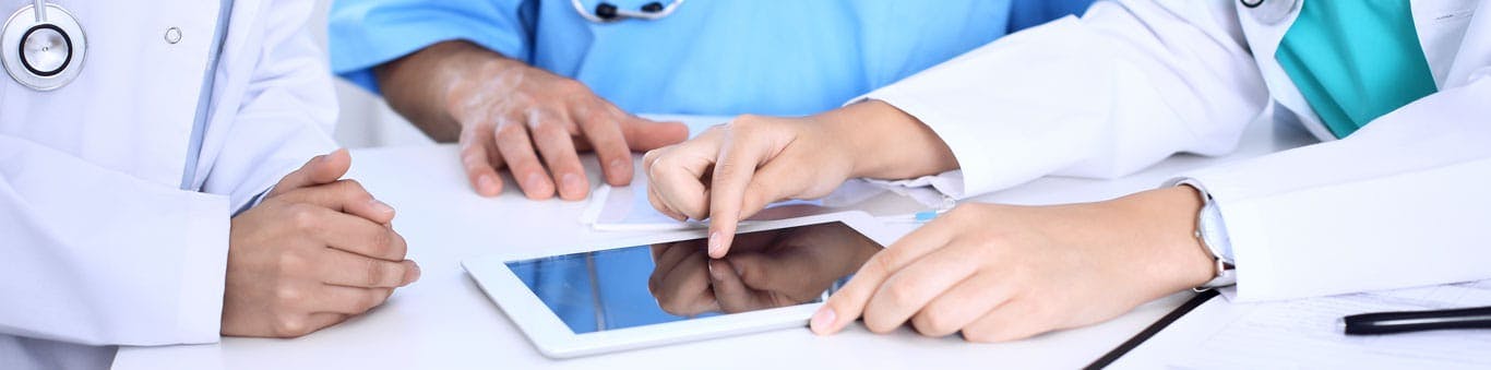 doctors looking at a tablet