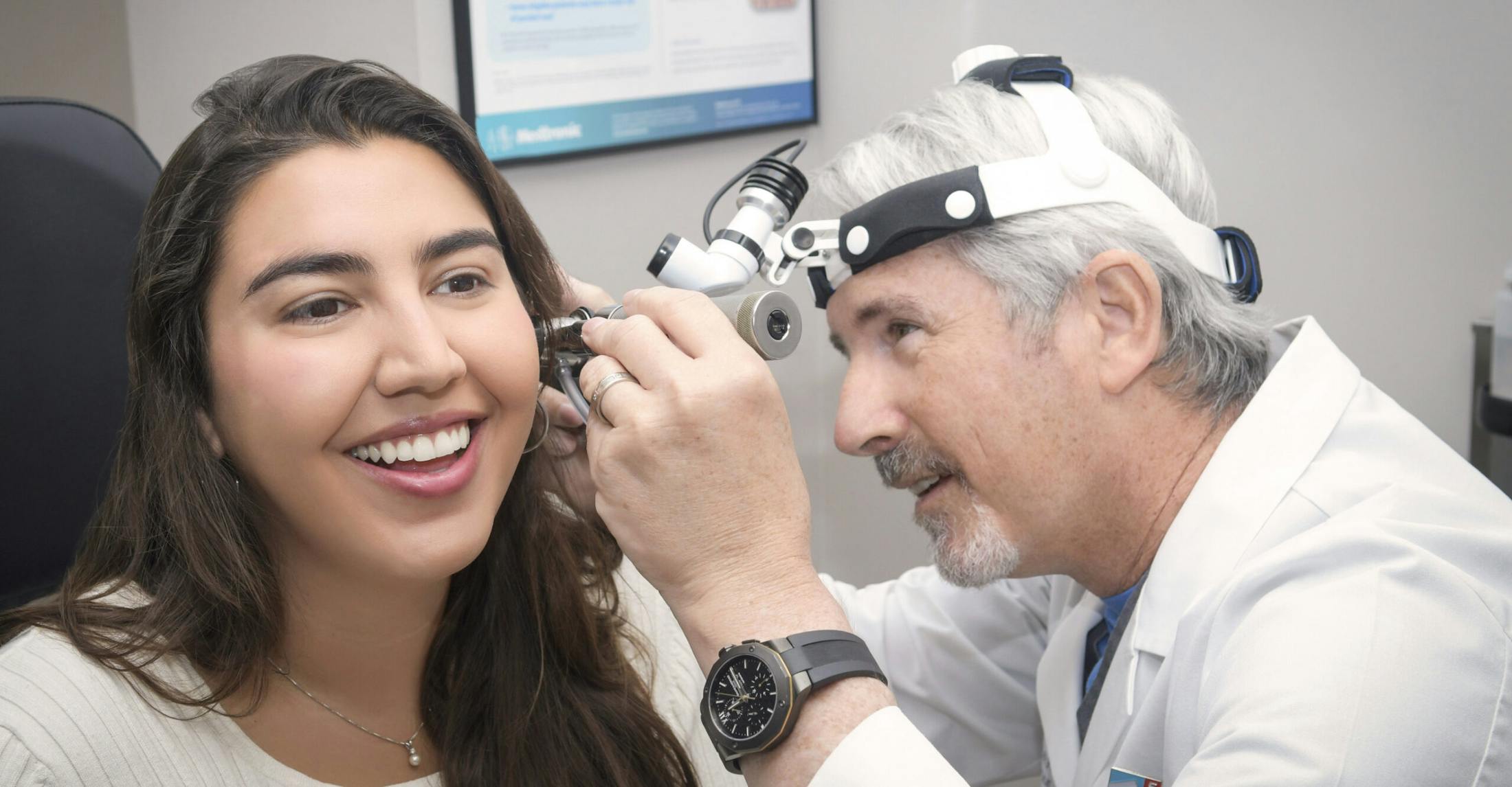 doctor looking in patient's ear
