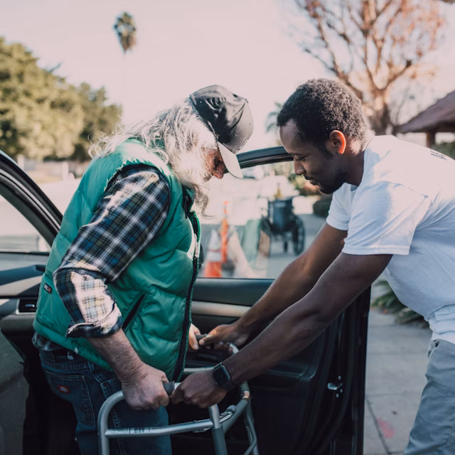 helping senior out of a car