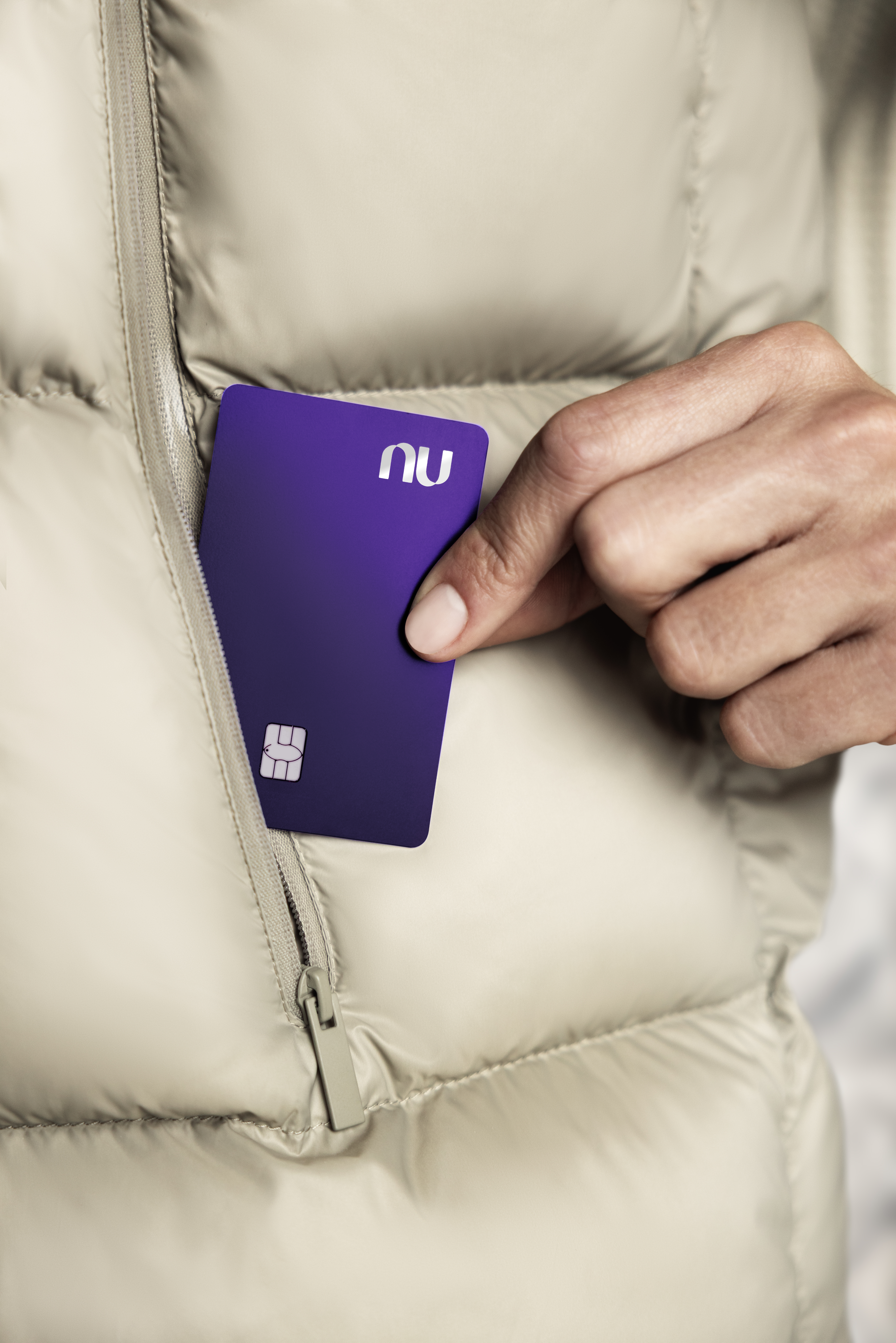 Uma pessoa retirando um cartão Ultravioleta do bolso de sua jaqueta.