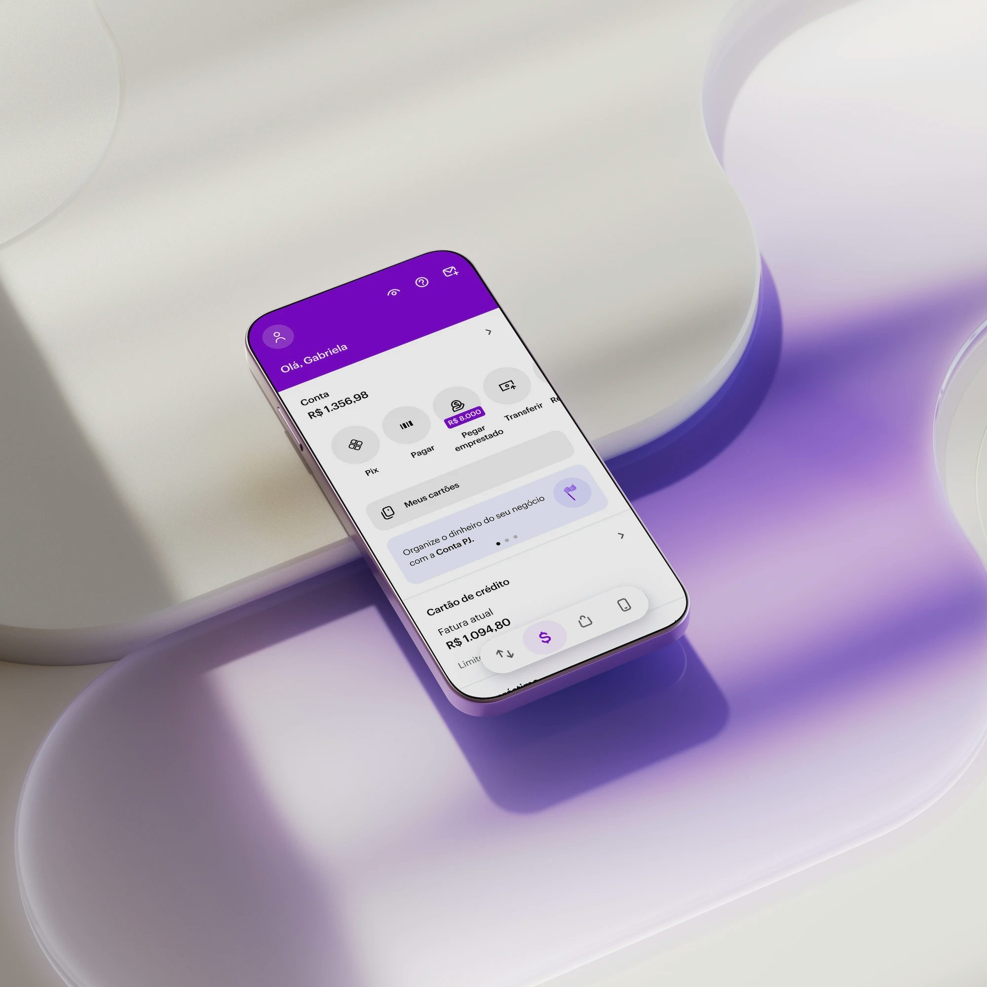 Celular apoiado em uma forma geométrica branca com aplicativo Nubank aberto na tela inicial.