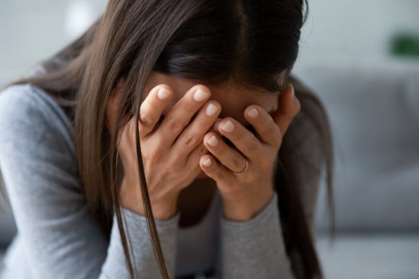 Woman Crying Covering Her Face With Hands