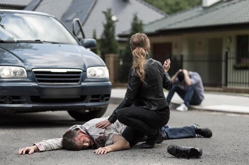 Woman Next To A Man On The Ground Hit By A Car