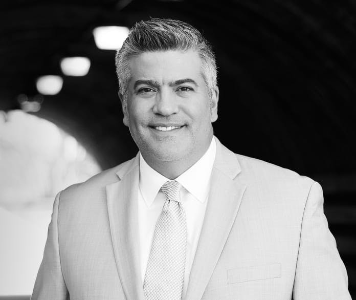 Dr. Higdon in a black and white suit
