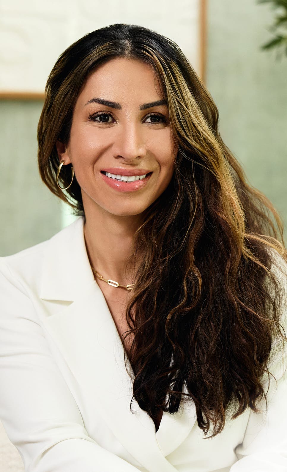 Woman with wavy hair in a suit