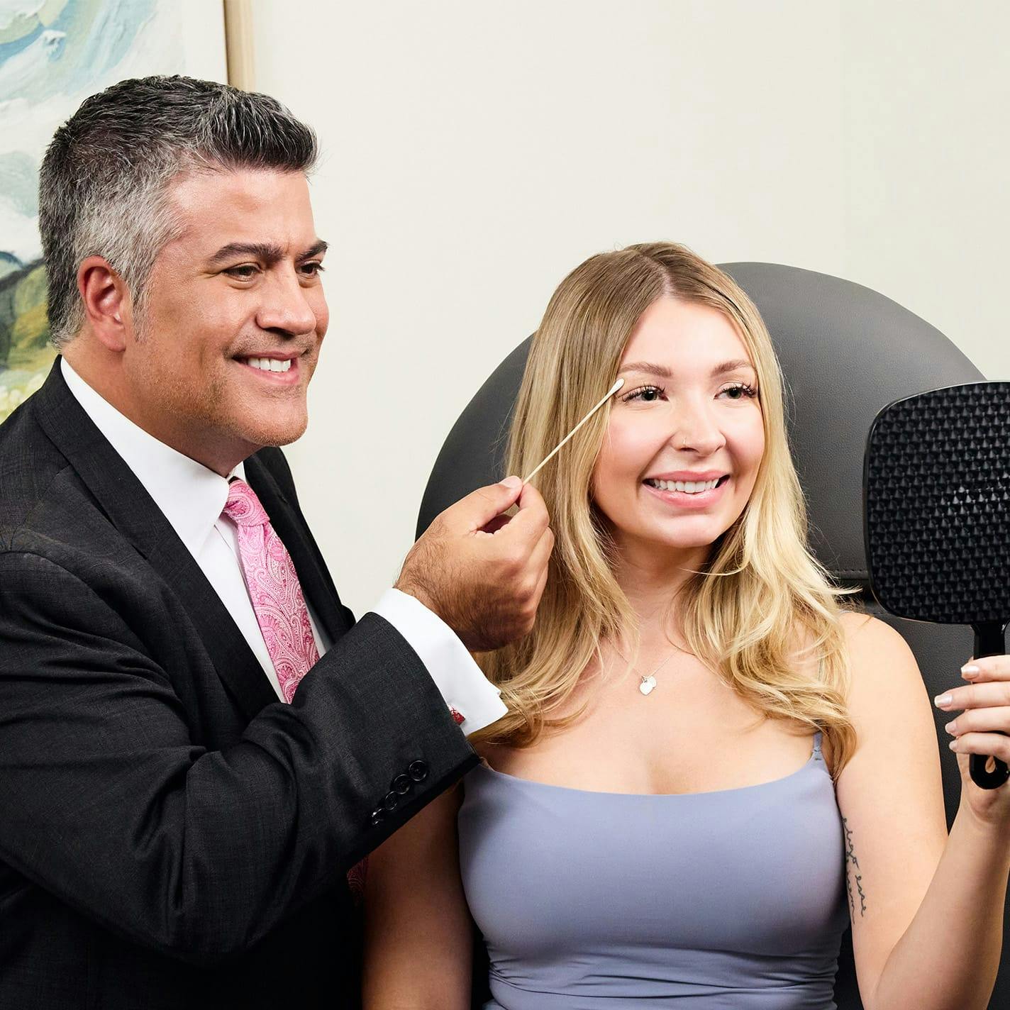 Dr. Higdon pointing to patients eyebrow