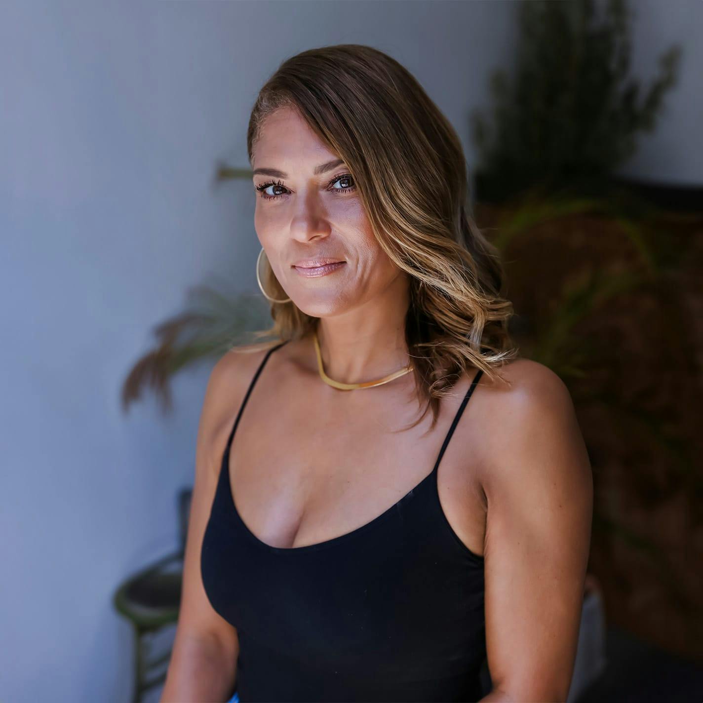 woman in black tank top looking forward