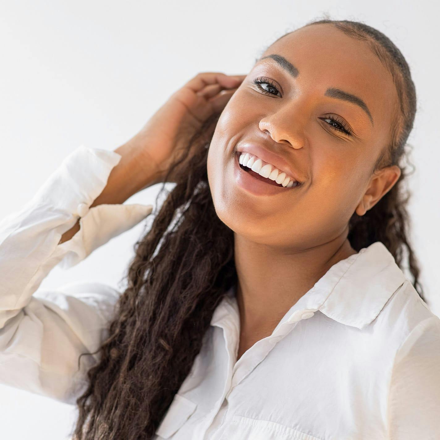 woman smiling with hand near her ear