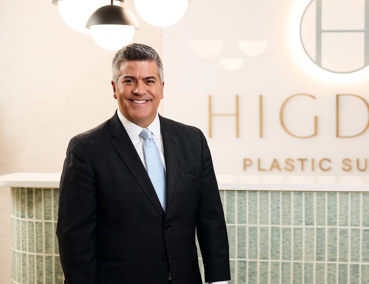 Dr. Higdon in front of the Higdon Plastic Surgery sign