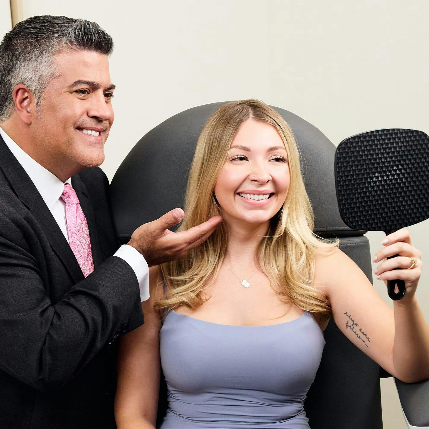 patient with Dr. Higdon, he is pointing to her cheek and shes looking through mirror