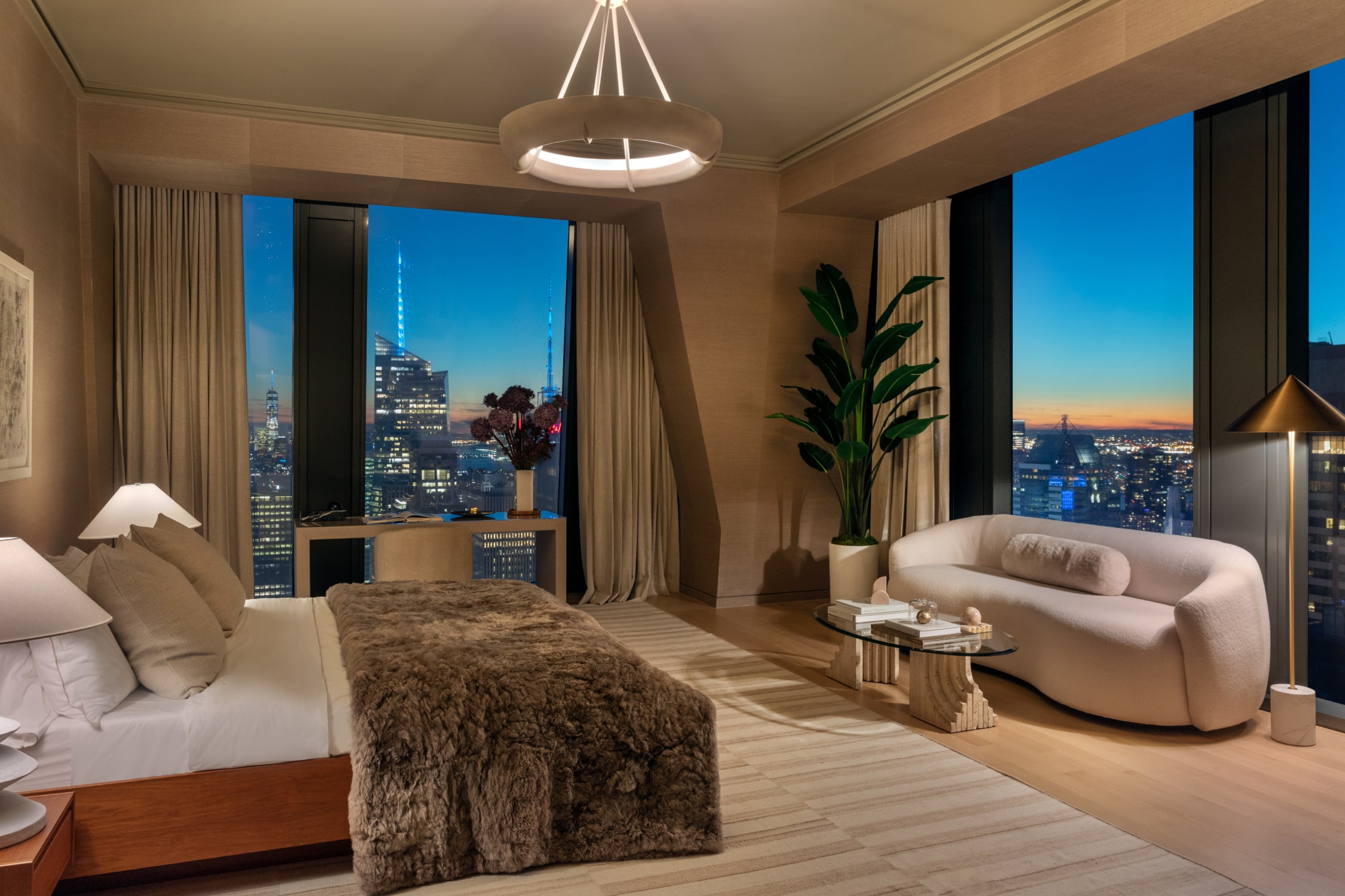 Exquisitely designed bedroom with floor to ceiling windows within a high rise penthouses for sale NYC