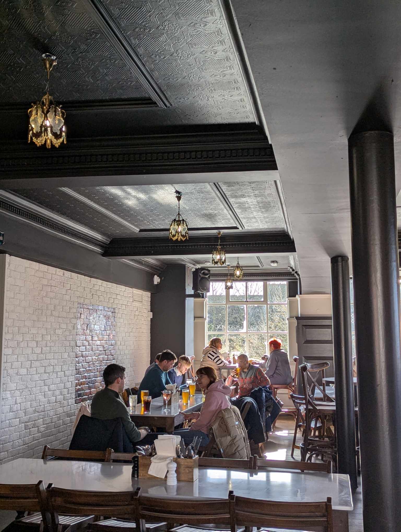 People eating at long table in Tower Street Food Hall