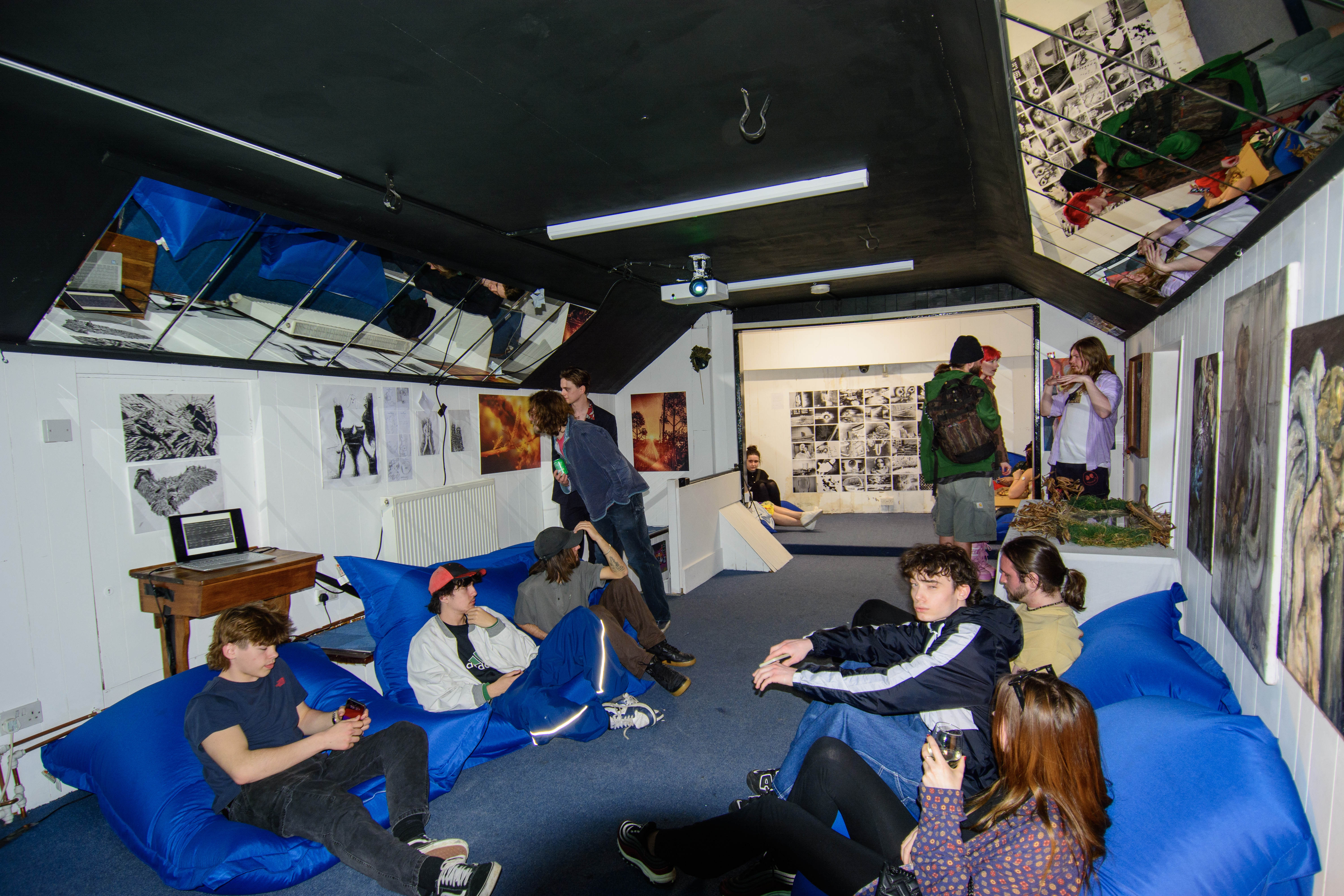 Artists sat on beanbags upstairs at The Hive surrounded by paintings