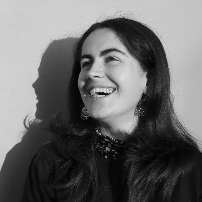 Black and white headshot of Amy Falla laughing