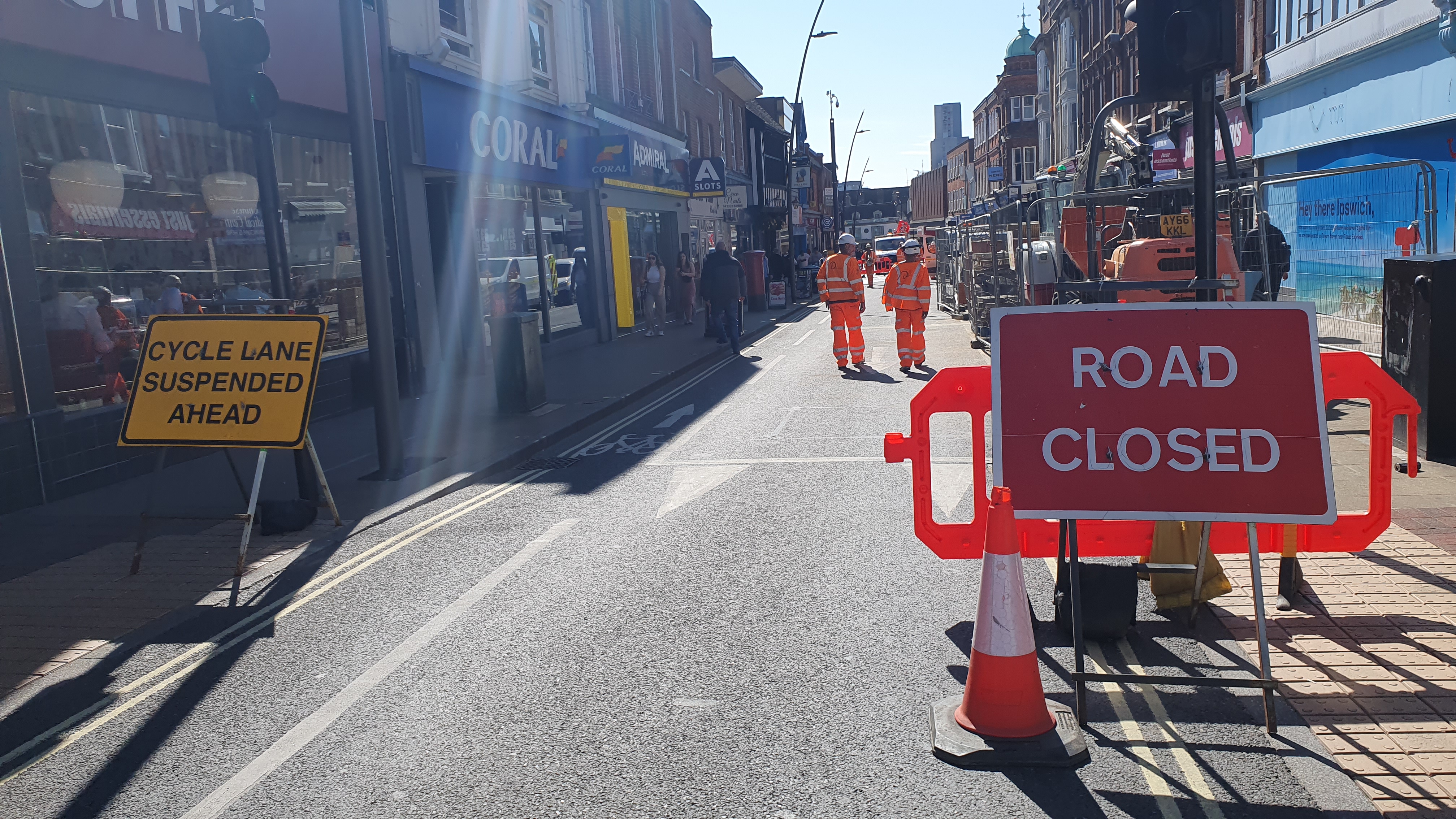 Road closure signs and workmen