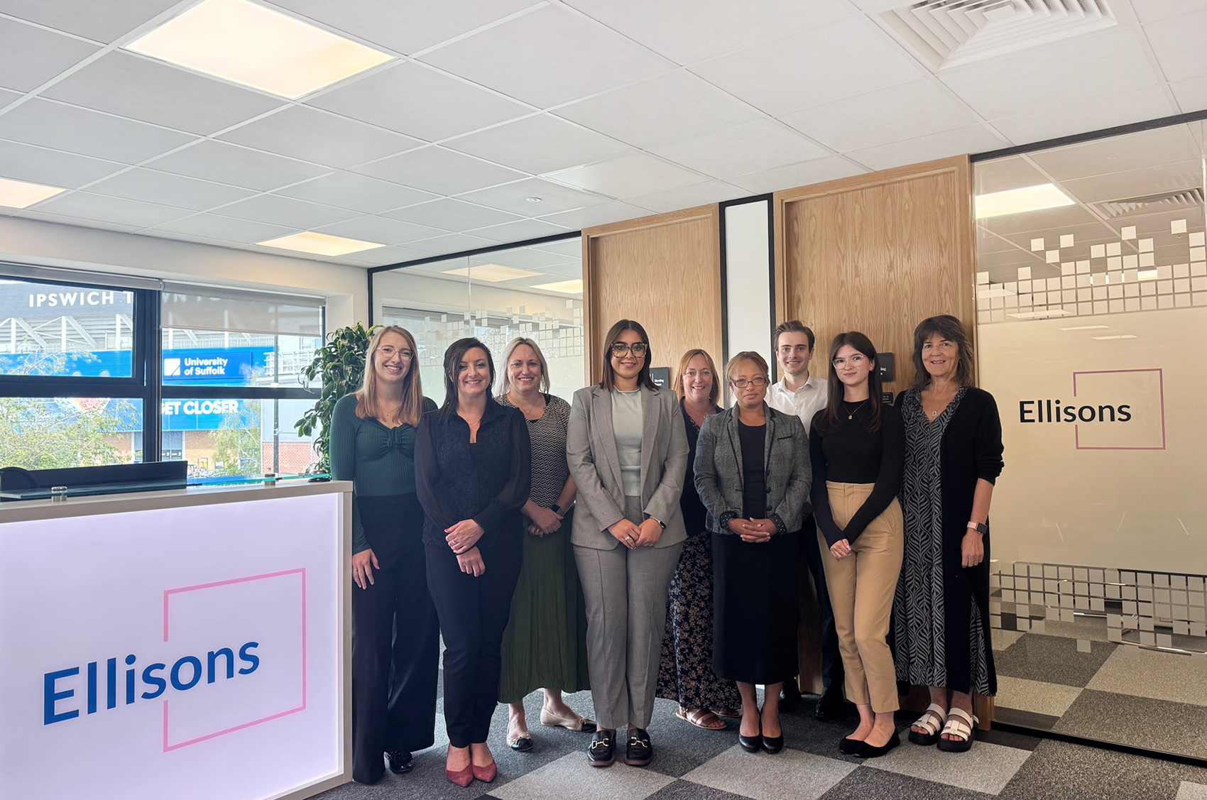 Group of people stood in office room