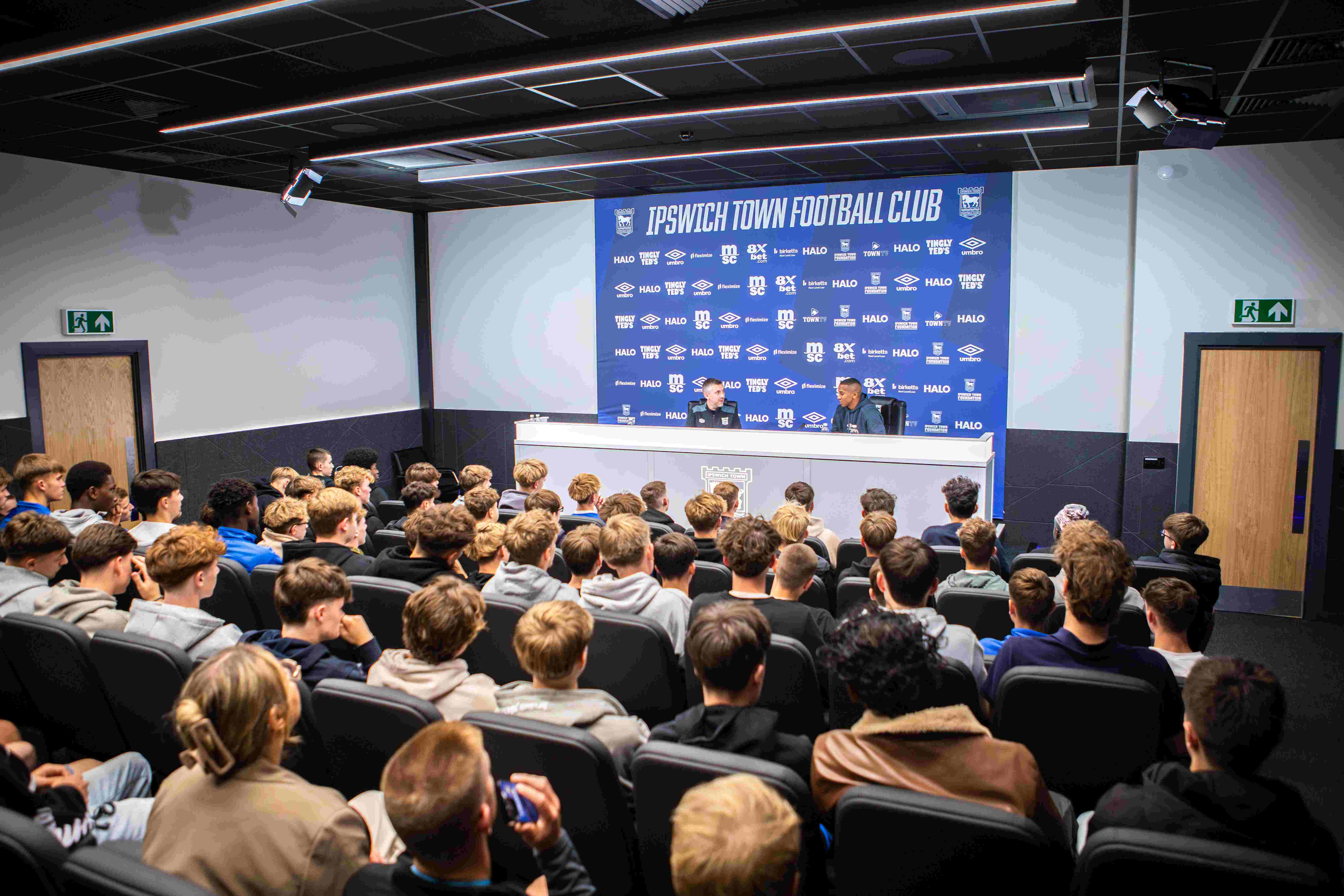 Robert Peace from Ipswich Town Foundation and Ashley Young chat to Suffolk New College students during a Q&A at Portman Road