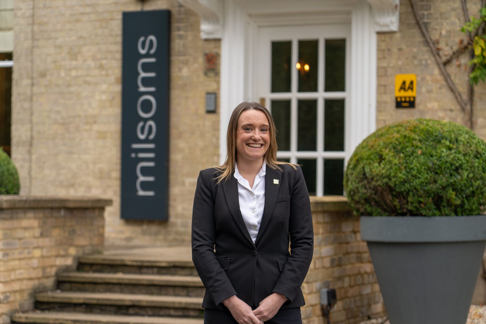 Woman happy in front of building