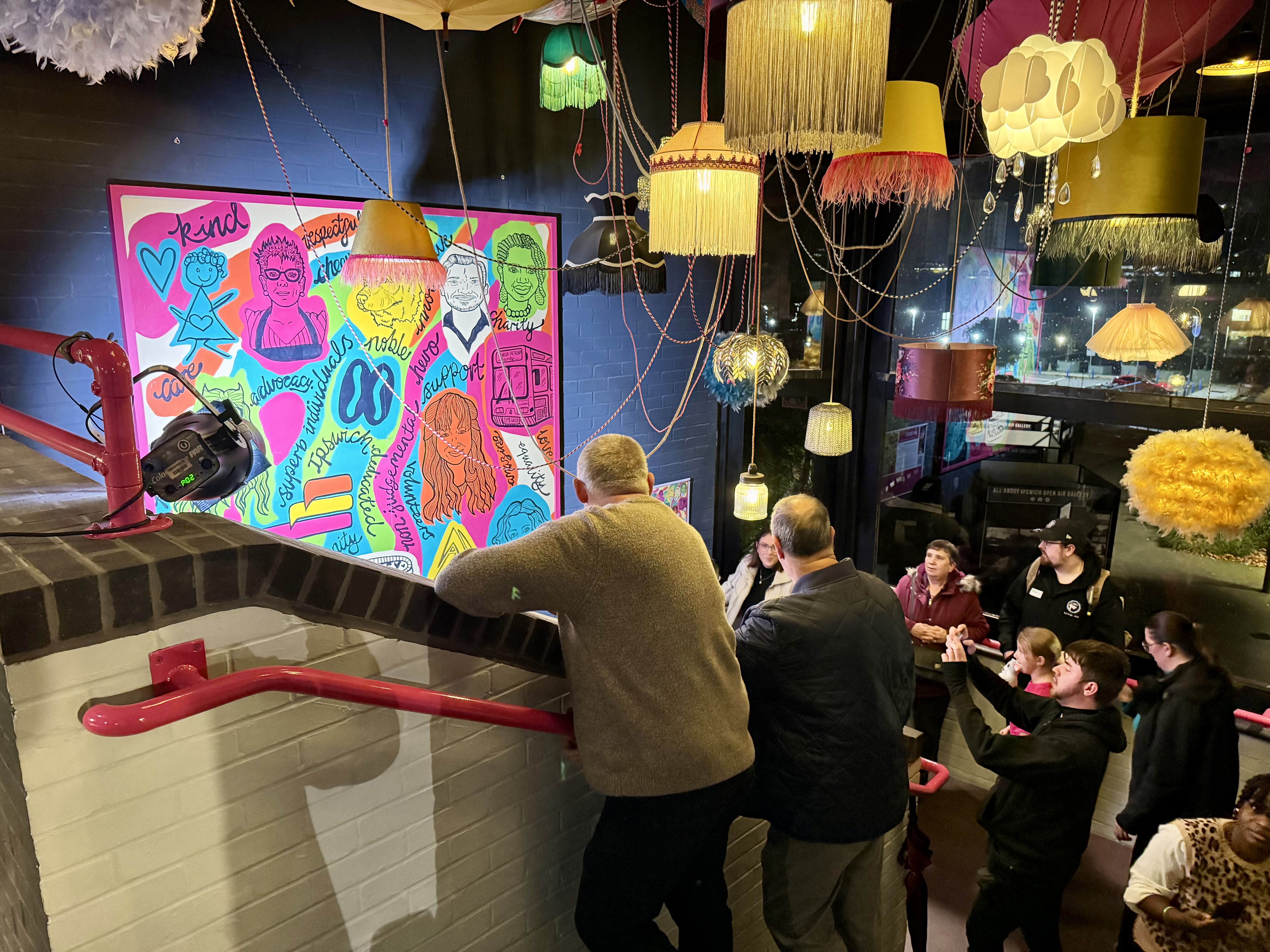 Community heroes admiring the mural with friends, family and guests