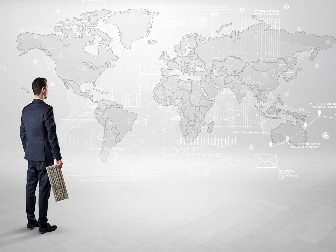 Mann steht vor einer Weltkarte Mann steht vor einer Weltkarte