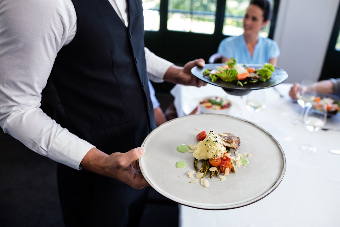 Kellner serviert hochwertiges Essen Kellner serviert hochwertiges Essen